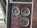 Dashboard gauges of a 2013 Kenworth T370 displaying voltmeter water temperature and oil pressure readings