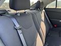 Interior view of a 2006 Pontiac G6 showing the back seat with black fabric upholstery and seatbelts