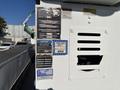 A 2013 International 7500 with various identification and warning labels attached to its side