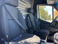 The image shows the interior of a 2021 Mercedes-Benz Sprinter 2500 with two black fabric front seats and seatbelts secured
