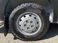 A close-up of a wheel and tire on a 2020 RAM ProMaster 3500 showcasing a silver rim with five bolt holes and a rugged black tire tread