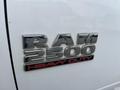 A close-up of the RAM 2500 Heavy Duty badge on a truck displaying a silver chrome finish with red detailing