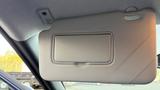 A 2019 Nissan Kicks sun visor is open displaying a mirror compartment without the mirror itself