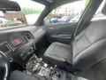 Interior view of a 2015 Dodge Charger showing the driver's seat dashboard and center console with controls and a touchscreen display