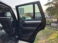 A 2013 BMW X3 with the driver's side door open showing the interior features and seat design