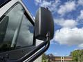 A close-up of the side mirror of a 2022 Lion Lion6 vehicle showing a sleek black design and a sturdy mounting arm