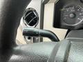 Close-up of the steering column controls in a 2008 Ford F-250 SD showing the wiper and turn signal stalk alongside the instrument panel