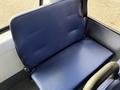 A blue fabric seat from a 2019 Chevrolet Express with a padded surface and backrest