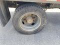 A close-up view of a 1996 GMC Top Kick tire showing visible wear and a rusted rim