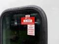 A red certification sticker on the window of a 2020 Peterbilt 330 indicating approval and listing months from July to November