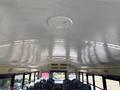Interior view of a 2013 International CE300 school bus showing the ceiling design and seating arrangement