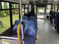 Interior of a 2020 Chevrolet Express with blue upholstered seats and metallic features showcasing an accessible design for passengers