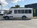 A white 2018 Ford Transit-350 van with large windows parked on a concrete surface