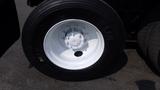 Close-up of a white wheel with a Michelin tire mounted on a 2003 International 5600i
