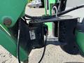 Close-up of the pivot mechanism of a 2015 JLG 450AJ with hydraulic lines and labels visible on the black component