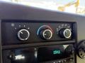 Control panel of a 2020 Chevrolet Express featuring temperature and fan speed dials along with a display showing the time