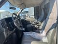 Interior of a 2011 Chevrolet Express showing the driver's seat dashboard and steering wheel with a mount for devices
