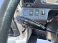 Close-up of a Hino 338 vehicle's turn signal and headlight control lever featuring various settings for lights and signal functions