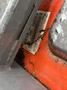 A close-up of a part of a 2012 Kubota F3680 with a visible identification label partially obscured by dirt and debris