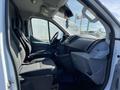 Interior view of a 2017 Ford Transit showing the driver's seat and passenger seat with a dashboard visible