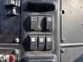 Control panel of a 2011 Autocar Xpeditor featuring buttons for power windows and mirrors