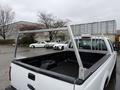 A white 2008 Ford F-250 SD with a truck bed rack installed in the back