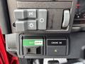 A close-up view of the control panel in a 2002 GMC C7500 showing switches for parking brake and lights along with a master switch labeled OFF and ENGINE ON with a green indicator light