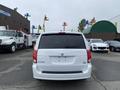 A 2014 RAM Cargo Van displayed from the rear with tinted windows and a simple design
