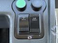 Close-up of a control panel in a 2016 Grande West Vicinity featuring two buttons labeled Normal Kneeling and Ramp Enable