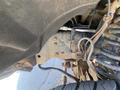 Underside view of a 2016 Ford F-350 SD highlighting the suspension components and frame with visible rust and mechanical details