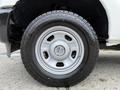 Close-up of a white wheel and tire on a 2015 Ford F-350 SD featuring a metallic silver rim and a rugged black tire tread