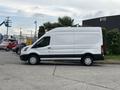 A 2020 Ford Transit 250 white cargo van is parked, featuring a tall roof and sliding side door with wheels and a smooth exterior design