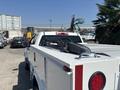 A white 2017 Chevrolet Colorado pickup truck with a tool rack mounted in the bed and red taillights visible