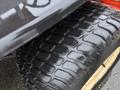 Close-up of a large tire from a 2012 Kubota F3680 showcasing its tread pattern and surface details