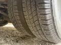 Close-up of a tire on a 2019 Chevrolet Express showcasing detailed tread patterns and slight dirt accumulation on the surface
