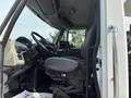 Interior view of a 2013 International WorkStar showing the driver's seat dashboard and control panel with various instruments and buttons