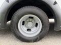 Close-up of a silver wheel with a black tire from a 2015 Chevrolet Express van
