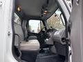 Interior view of a 2013 Freightliner 114SD with a driver's seat and gear shifter visible