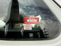 A red certification sticker attached to the window of a vehicle displaying the year 2026 and the words certificate of approval along with the months January February and March