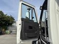 A 2013 International WorkStar with its driver's side door open showcasing the interior and door panel details