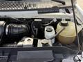An engine compartment of a 2008 Ford Econoline showing the air intake system battery and reservoir tanks