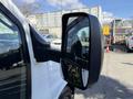 A side mirror of a 2017 Chevrolet Express showing a reflection of nearby vehicles