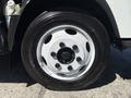 Close-up of a wheel on a 2022 Isuzu NRR featuring a white rim with six lug nuts and a black tire