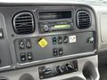 Interior dashboard of a 2016 Freightliner 108SD with various control switches a radio and climate controls