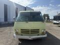 A 1976 GMC Motorhome with a distinctive yellow-green exterior featuring a large front windshield and multiple headlights