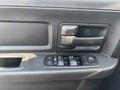 Interior door panel of a 2013 RAM 5500 featuring a door handle and control buttons for windows and locks