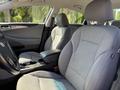 Interior view of a 2015 Hyundai Sonata showing gray fabric seats and a steering wheel with controls