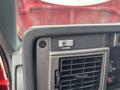 Close-up of the dashboard controls in a 2002 GMC C7500 featuring a button labeled PTO ENABLE and an air vent