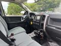 A 2016 RAM 1500 interior with gray seating a dashboard featuring a touchscreen display and various controls