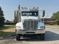A 2008 Peterbilt 340 truck with a shiny chrome grille and multiple amber lights on the roof is positioned facing forward